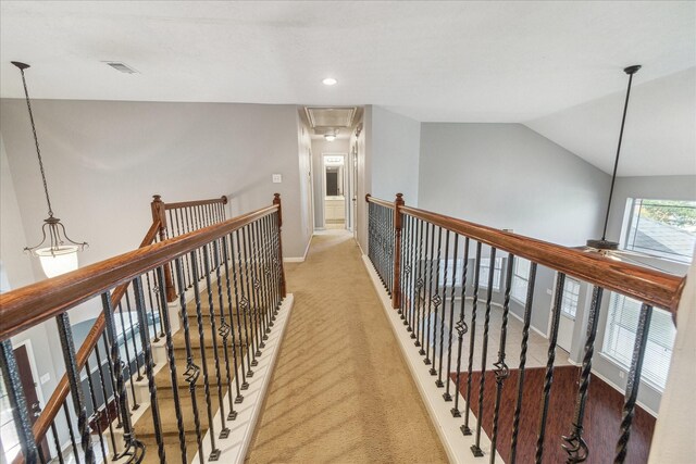 hallway featuring an upstairs landing, light carpet, baseboards, recessed lighting, and lofted ceiling