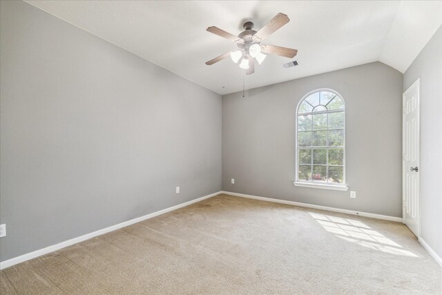 unfurnished room with lofted ceiling, ceiling fan, carpet, and baseboards