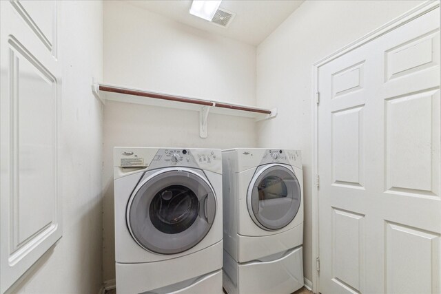 laundry room featuring separate washer and dryer