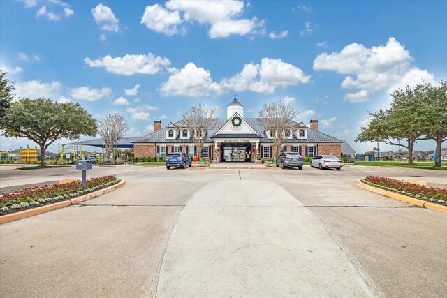 view of building exterior featuring uncovered parking