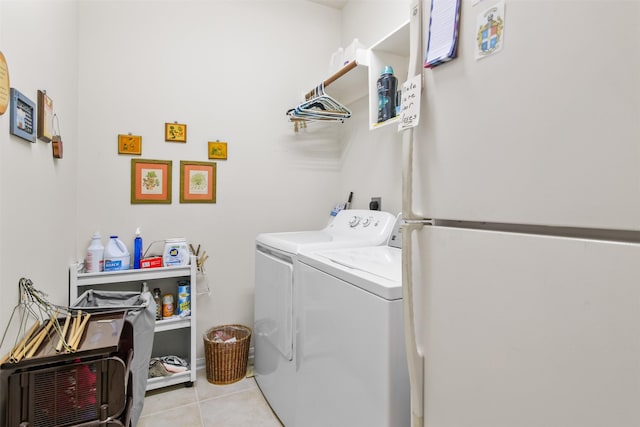 clothes washing area with independent washer and dryer and tile patterned flooring