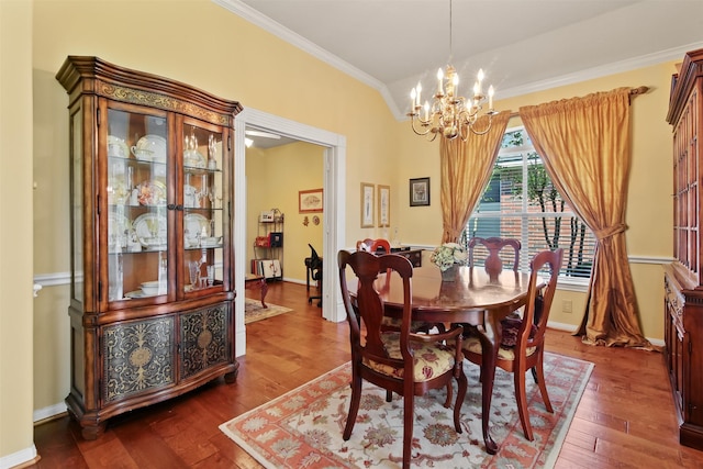 dining area featuring ornamental molding, a chandelier, dark wood finished floors, and baseboards
