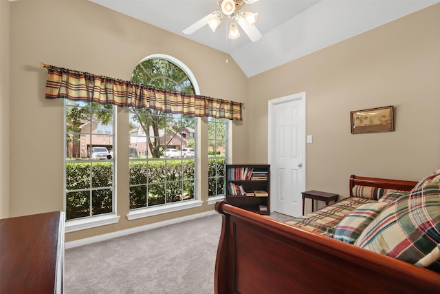 carpeted bedroom with vaulted ceiling, baseboards, and ceiling fan