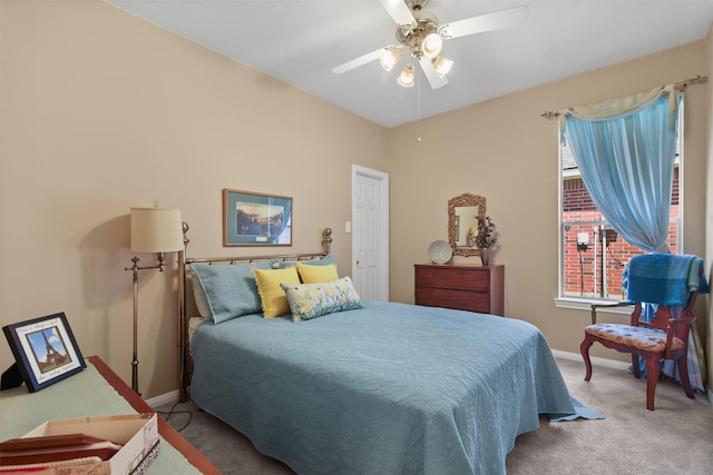 carpeted bedroom with baseboards and ceiling fan