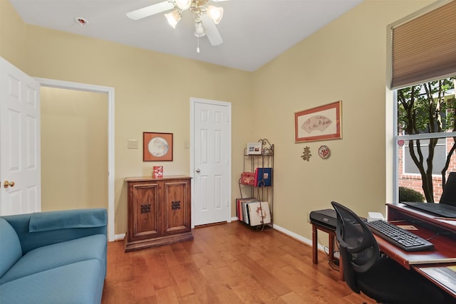 office with wood finished floors, a ceiling fan, and baseboards
