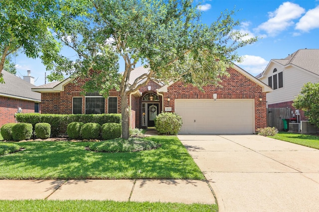 traditional home with brick siding, a garage, concrete driveway, and a front lawn