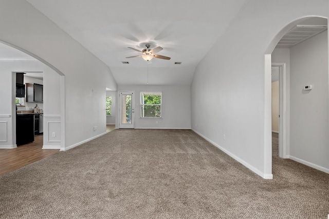 13228 Miller Ln, Willis, TX 77318 - unfurnished living room with carpet floors, a ceiling fan, baseboards, and vaulted ceiling