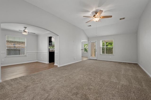 13228 Miller Ln, Willis, TX 77318 - carpeted spare room with ceiling fan, lofted ceiling, and arched walkways