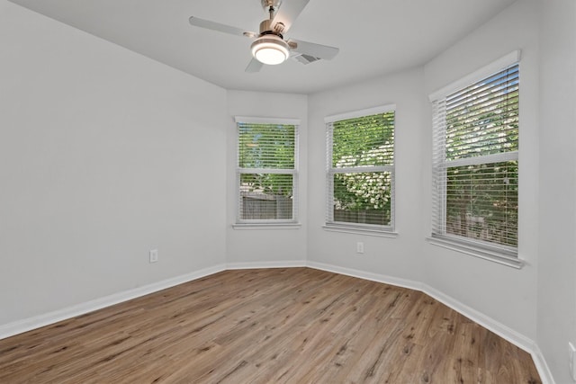 13228 Miller Ln, Willis, TX 77318 - spare room featuring light wood-type flooring, baseboards, and ceiling fan