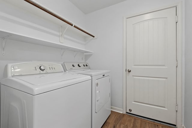 13228 Miller Ln, Willis, TX 77318 - clothes washing area featuring independent washer and dryer and dark wood finished floors