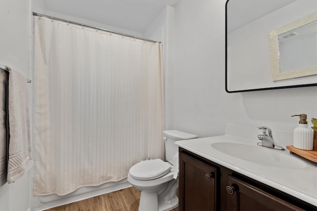 13228 Miller Ln, Willis, TX 77318 - bathroom with toilet, vanity, wood finished floors, and shower / bathtub combination with curtain