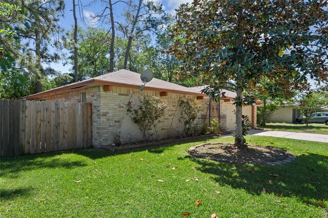 view of home's exterior with brick siding and concrete driveway