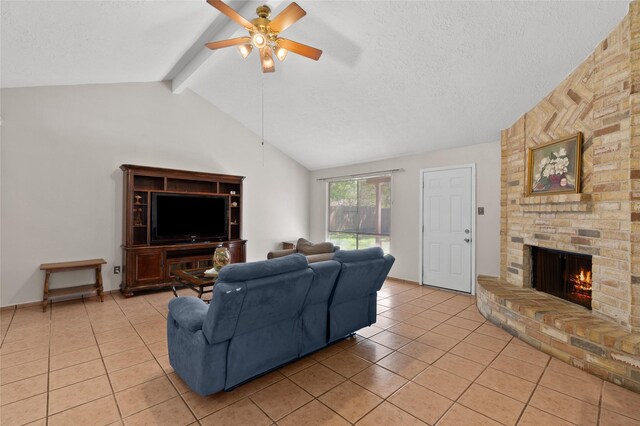 living room with light tile patterned floors, a ceiling fan, a brick fireplace, and a textured ceiling