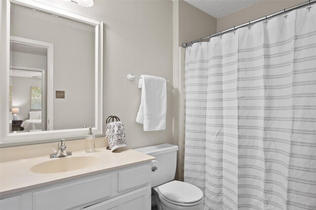 full bath with toilet, connected bathroom, and vanity