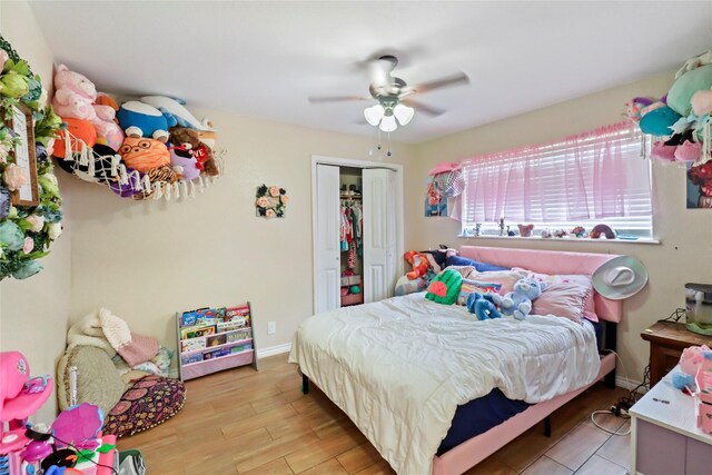 bedroom featuring a closet, a ceiling fan, and light wood-style flooring