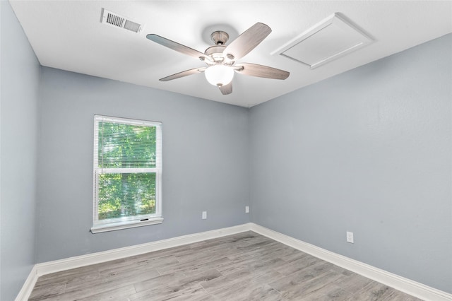 unfurnished room with a ceiling fan, wood finished floors, and baseboards