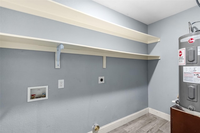 clothes washing area featuring electric water heater, electric dryer hookup, washer hookup, wood finished floors, and baseboards
