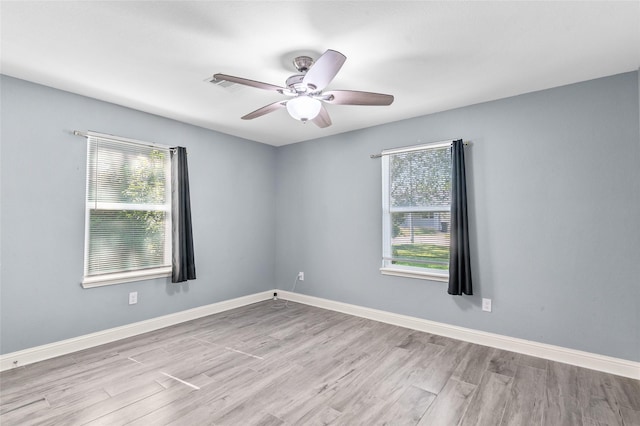 unfurnished room featuring wood finished floors, ceiling fan, and baseboards