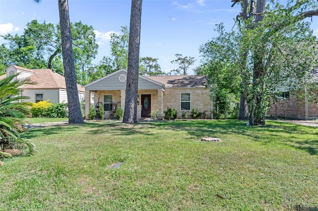 view of front of house featuring stone siding, a front yard, and covered porch