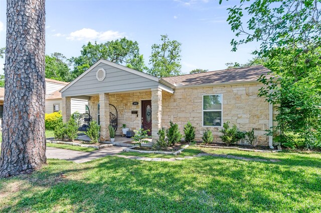3853 Rosedale St, Houston, TX 77004 - view of front of property featuring stone siding, a front lawn, covered porch, and a shingled roof
