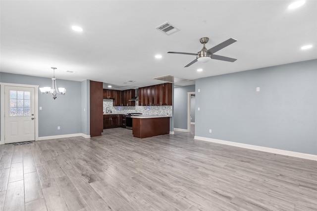 kitchen with open floor plan, light countertops, recessed lighting, stainless steel range with electric cooktop, and baseboards
