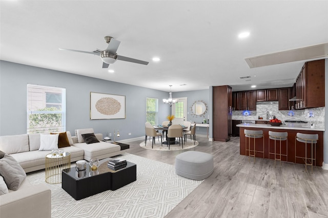 3853 Rosedale St, Houston, TX 77004 - living room with light wood-style floors, attic access, recessed lighting, a ceiling fan, and a chandelier