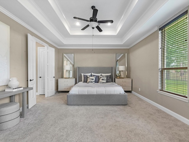20722 Lavone Dr, Porter, TX 77365 - carpeted bedroom featuring a raised ceiling, multiple windows, ornamental molding, ceiling fan, and baseboards