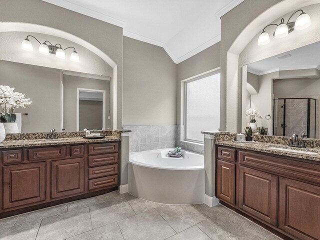 20722 Lavone Dr, Porter, TX 77365 - bathroom featuring crown molding, a stall shower, two vanities, a bath, and tile patterned flooring