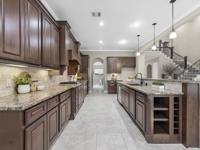 20722 Lavone Dr, Porter, TX 77365 - kitchen featuring arched walkways, open shelves, appliances with stainless steel finishes, a sink, and crown molding