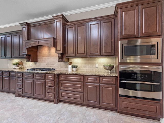 20722 Lavone Dr, Porter, TX 77365 - kitchen with appliances with stainless steel finishes, ornamental molding, backsplash, and light stone countertops