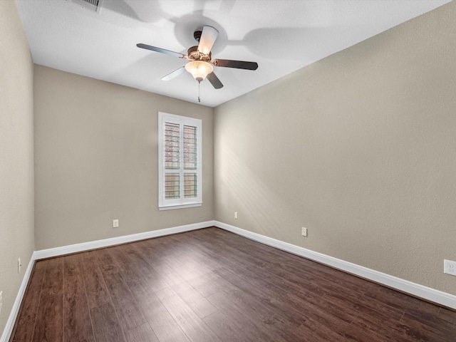 20722 Lavone Dr, Porter, TX 77365 - spare room with dark wood-type flooring, a ceiling fan, and baseboards