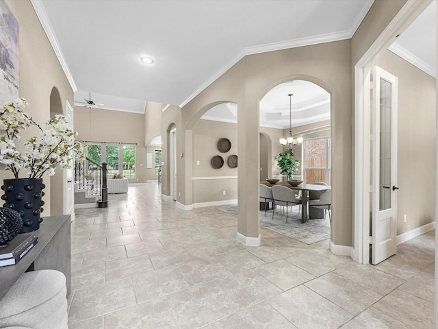 20722 Lavone Dr, Porter, TX 77365 - foyer featuring ornamental molding, baseboards, a ceiling fan, and arched walkways