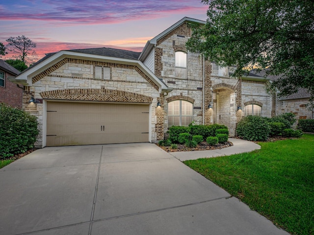 20722 Lavone Dr, Porter, TX 77365 - french provincial home with stone siding, concrete driveway, a garage, and a yard