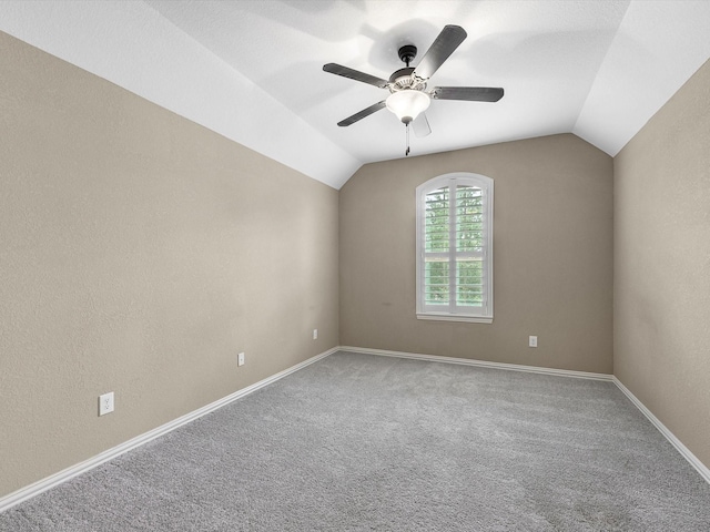 20722 Lavone Dr, Porter, TX 77365 - empty room with vaulted ceiling, carpet floors, a ceiling fan, and baseboards