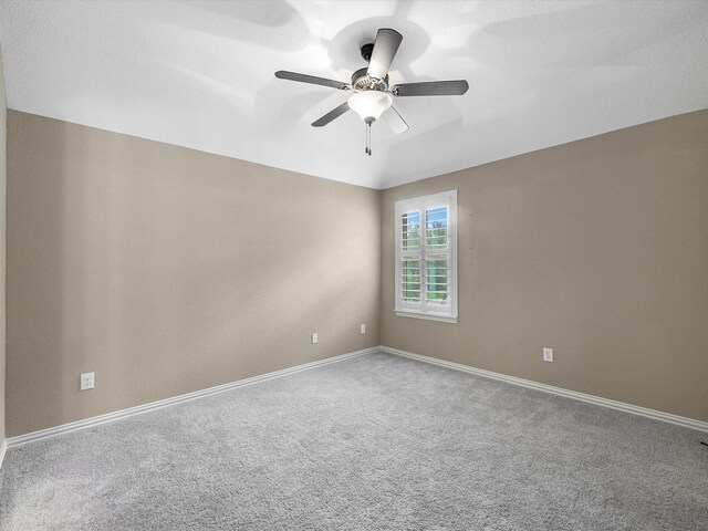 20722 Lavone Dr, Porter, TX 77365 - empty room featuring carpet flooring, ceiling fan, baseboards, and vaulted ceiling