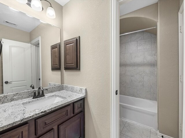 20722 Lavone Dr, Porter, TX 77365 - bathroom with vanity, marble look tile flooring, and tub / shower combination