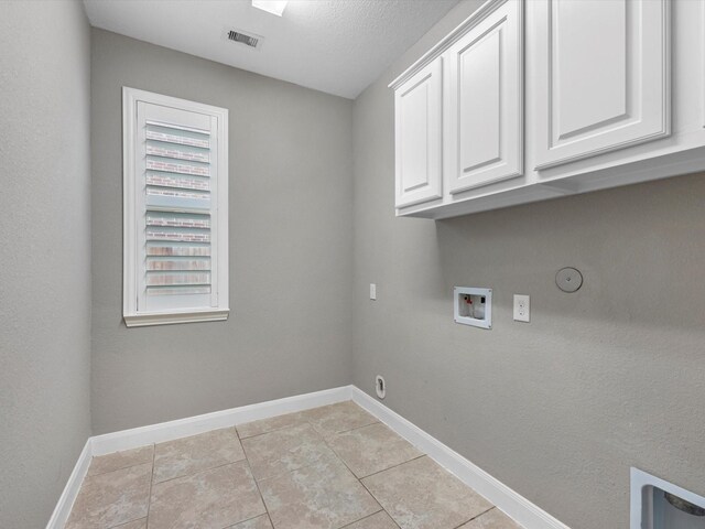 20722 Lavone Dr, Porter, TX 77365 - washroom with cabinet space, hookup for a washing machine, baseboards, hookup for a gas dryer, and light tile patterned floors