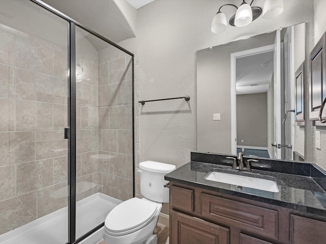 20722 Lavone Dr, Porter, TX 77365 - full bath featuring a stall shower, a textured wall, toilet, and vanity