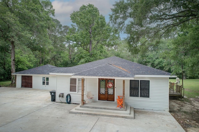 9471/2 Lake Glen Rd, Huffman, TX 77336 - single story home featuring roof with shingles, concrete driveway, and french doors