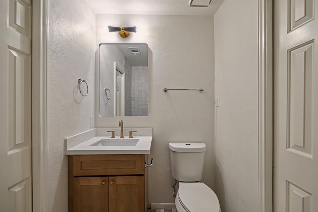 bathroom with toilet and vanity
