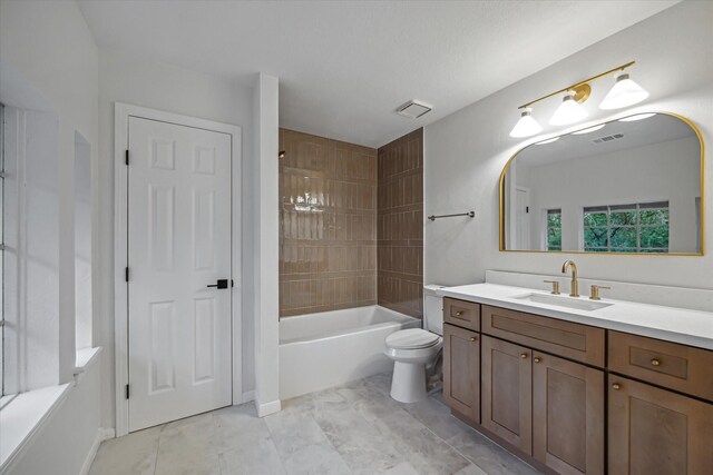 full bath featuring toilet, vanity, and tub / shower combination