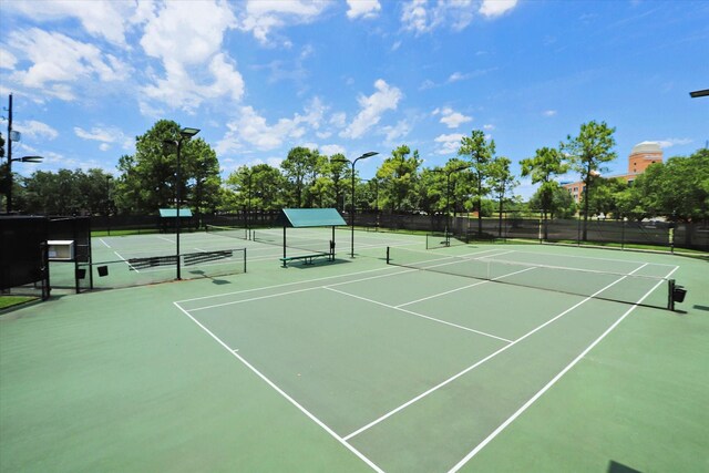 view of tennis court with fence and community basketball court