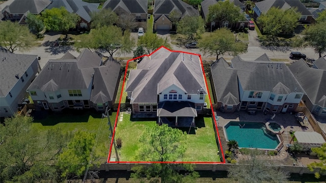 aerial perspective of suburban area with a pool area and property parcel outlined