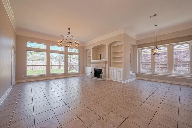 unfurnished living room with ornamental molding, a chandelier, built in features, light tile patterned floors, and plenty of natural light