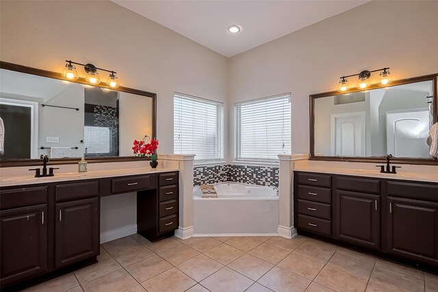 full bath with tile patterned floors, two vanities, a bath, and recessed lighting