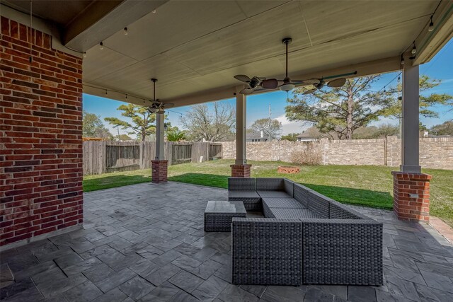 view of patio with outdoor lounge area and ceiling fan