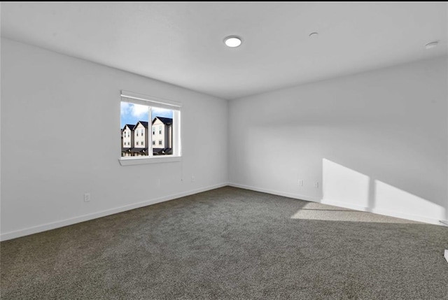 12603 Telge Rd Unit 11E-F, Cypress, TX 77429 - empty room featuring dark colored carpet and baseboards