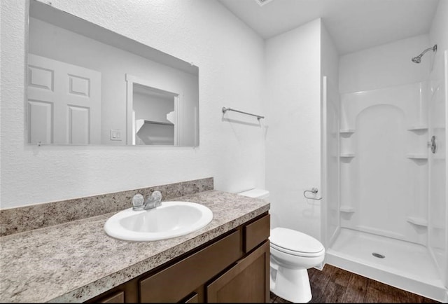 12603 Telge Rd Unit 11E-F, Cypress, TX 77429 - bathroom featuring a stall shower, vanity, and wood finished floors