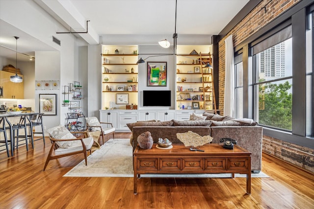 living room with wood finished floors and built in features