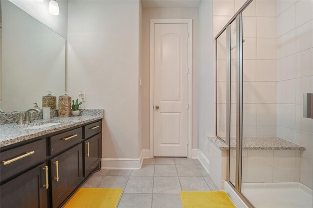 bathroom featuring a shower stall, tile patterned floors, vanity, and baseboards